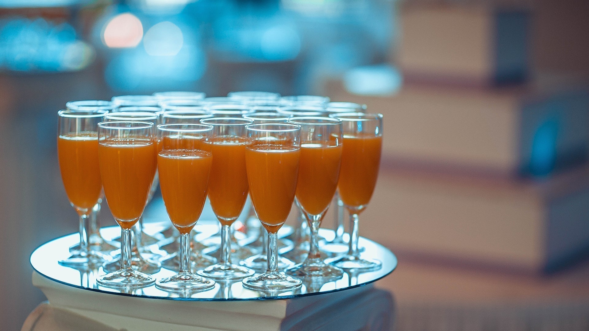 Elegant display of orange juice in tall glasses for a party or event catering.