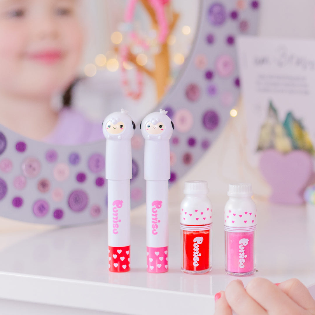 Four bottles of Purriso makeup. Two are in the shape of sheep. Bottles feature heart patterns. The makeup is red and pink. A girl's reflection is in the background.