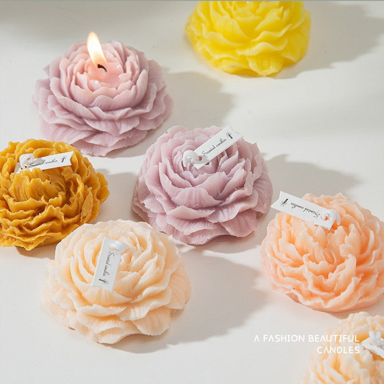 Lavender soy wax candles by Jellycup, shaped like peony flowers with textured petals and paper labels.