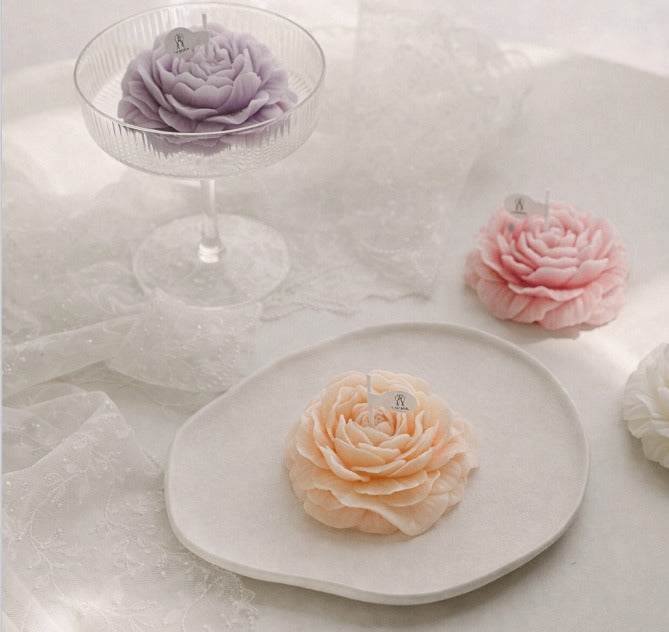 Lavender peony flower soy wax candle from Jellycup, displayed in a stemmed glass with decorative lace.