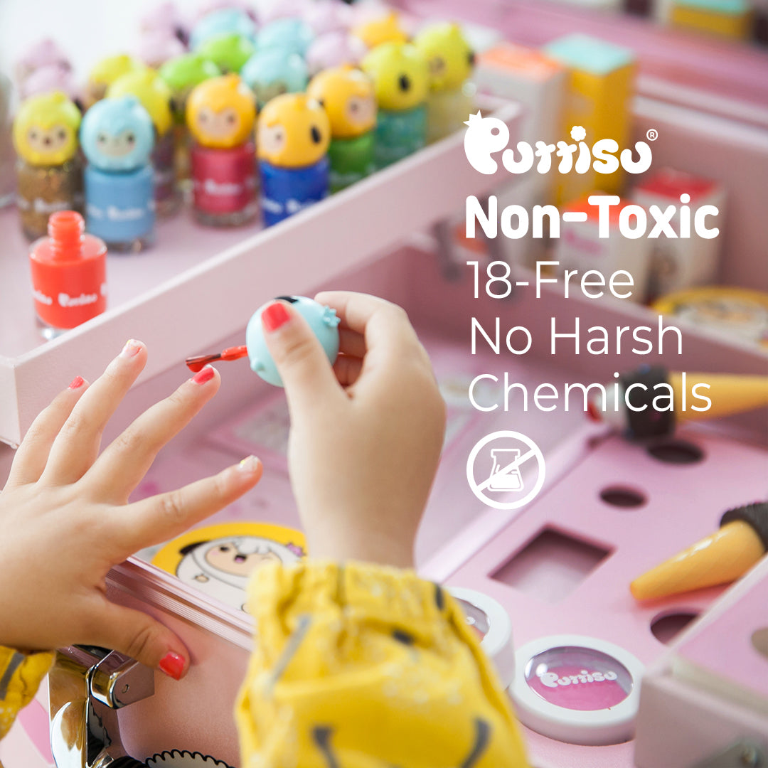 Child applying red nail polish with blue applicator. Pink makeup kit, toy nail polish bottles, and white text reading "Non-Toxic 18-Free No Harsh Chemicals".
