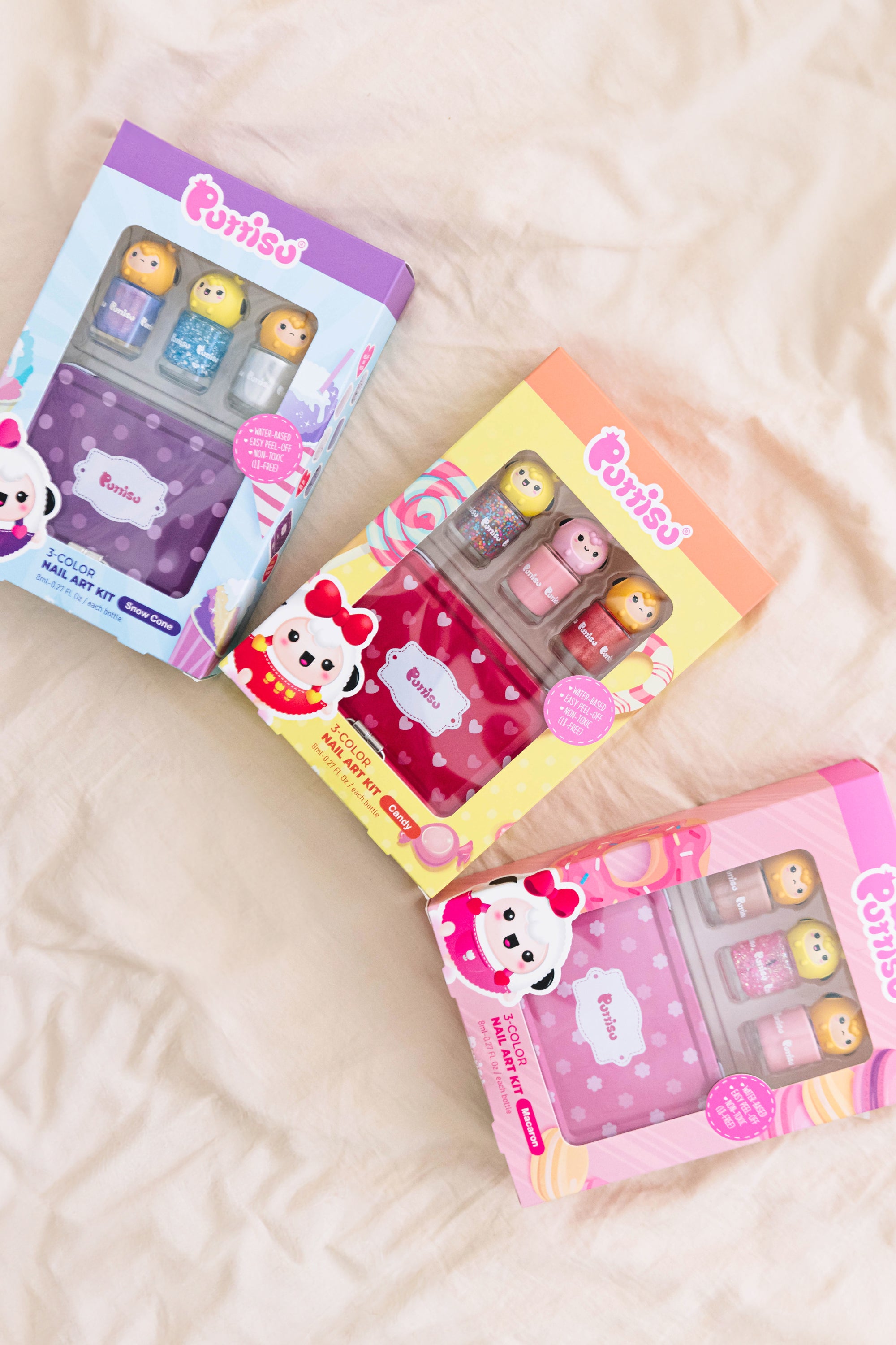 Three colorful Purriso nail art kits on a white textured surface.