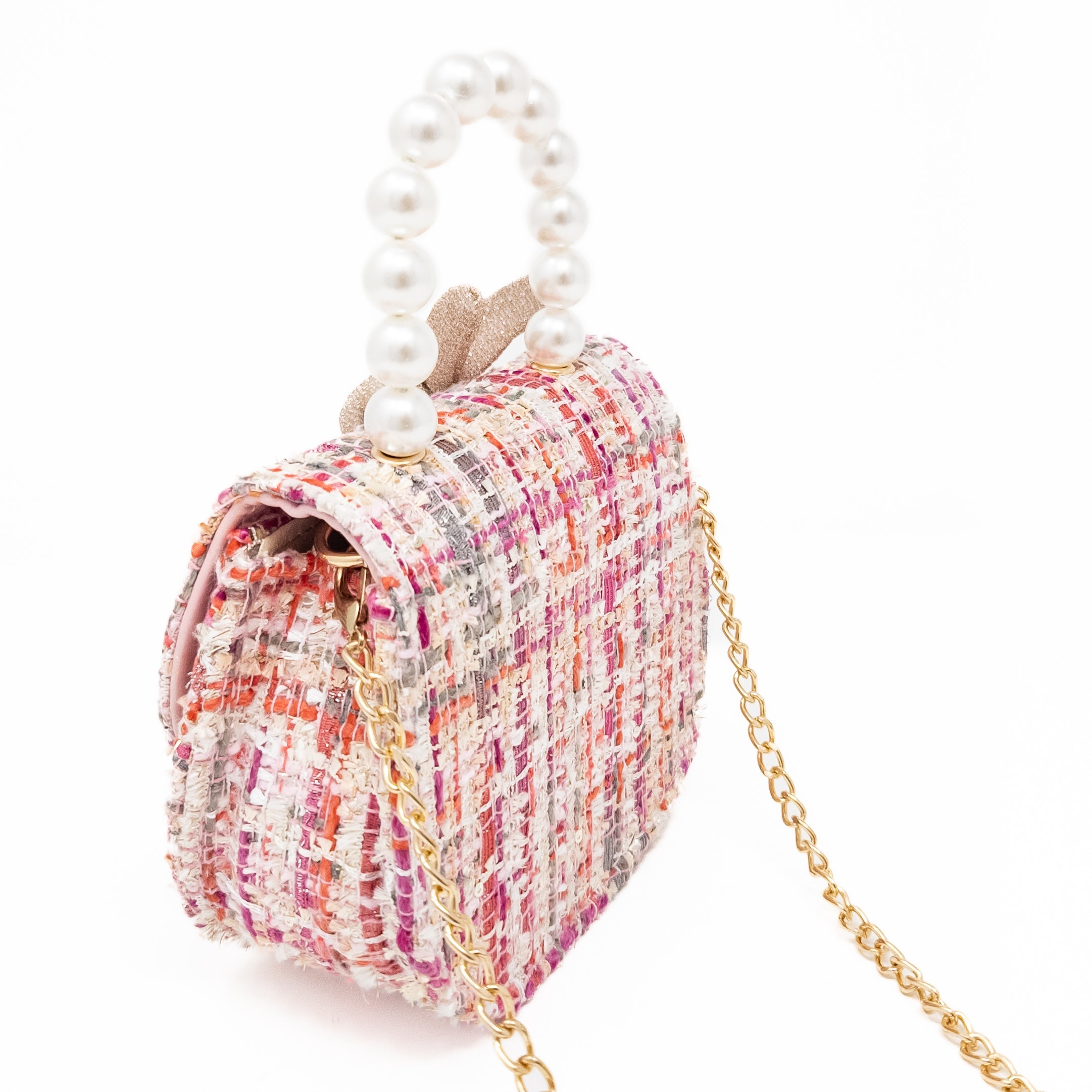 Pink tweed handbag with pearl handle and gold chain.