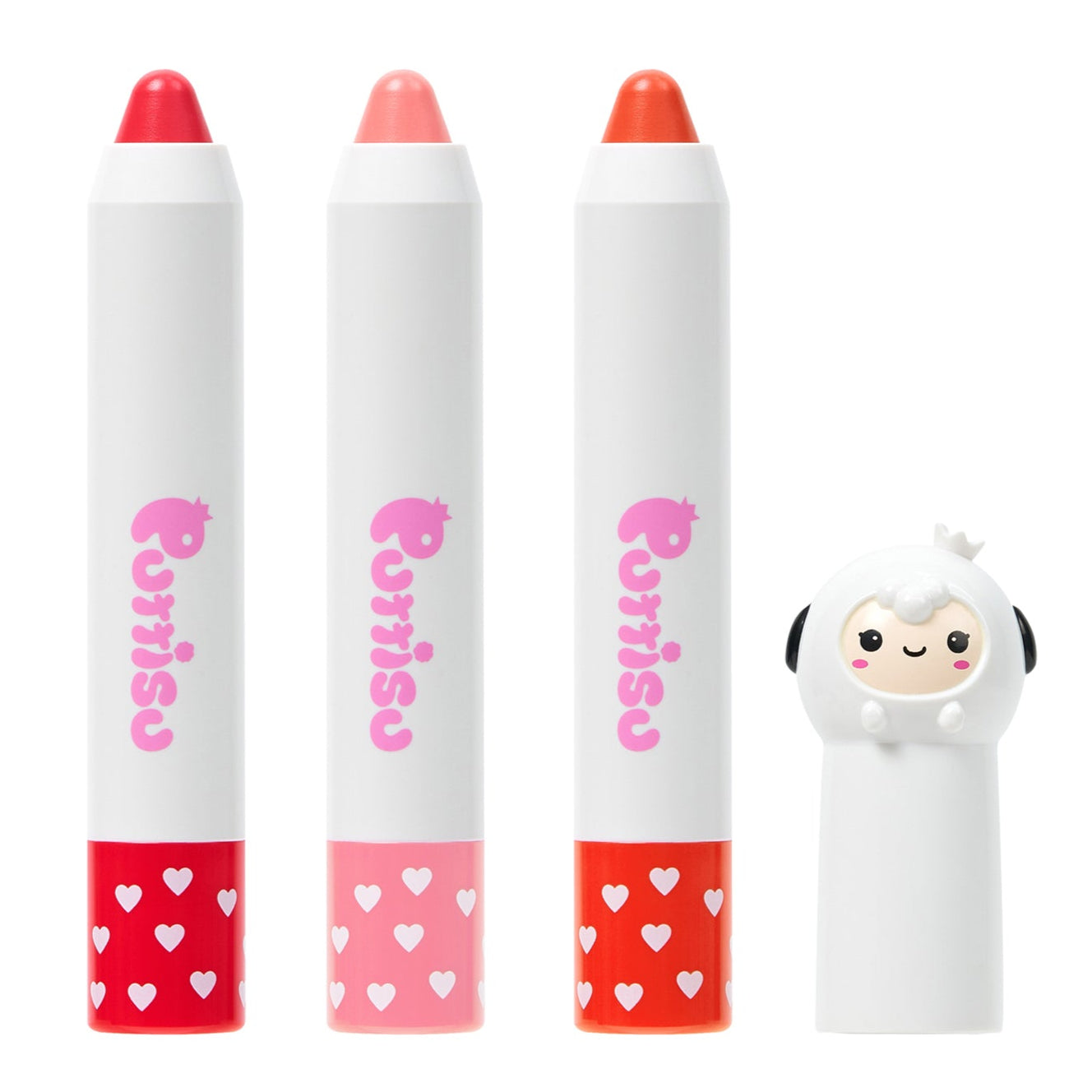 Three Purito lip crayon tubes in red, pink, and orange next to a sheep shaped lip balm container.