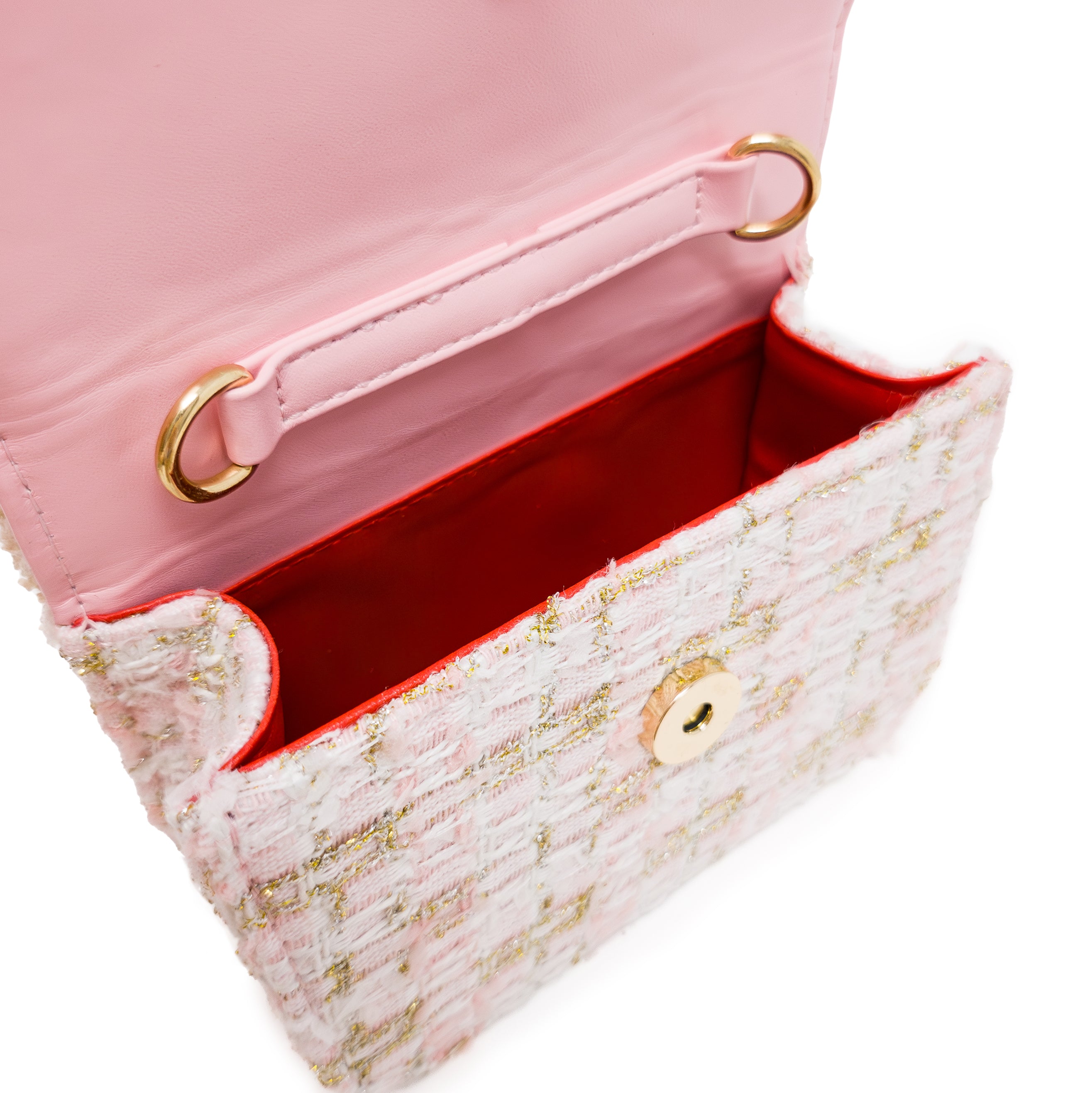 Puttisu Pearl Garden Rosy Peony. Close-up of a pink, gold textured handbag with red interior and gold accents on a white background