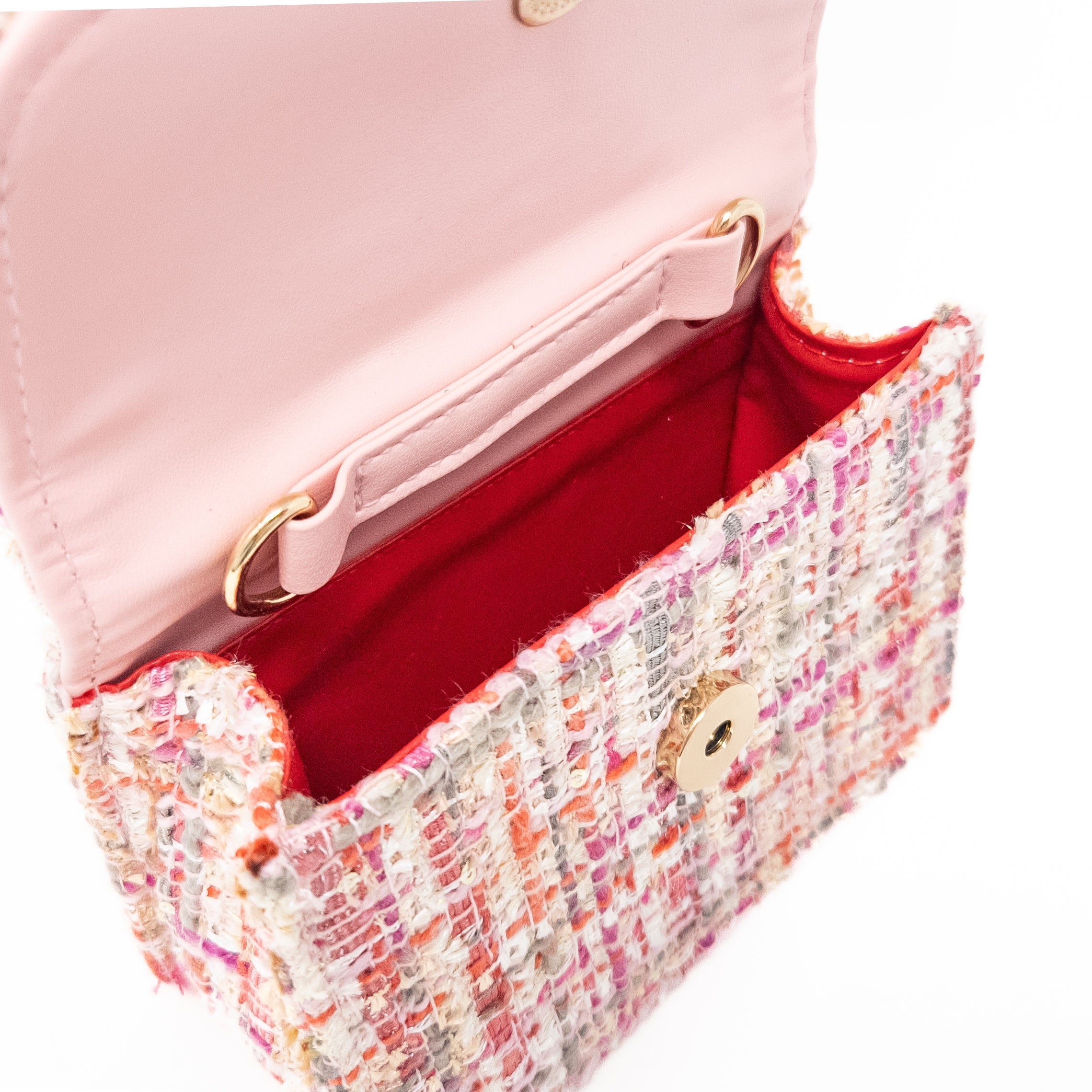 Open pink tweed handbag with red interior.