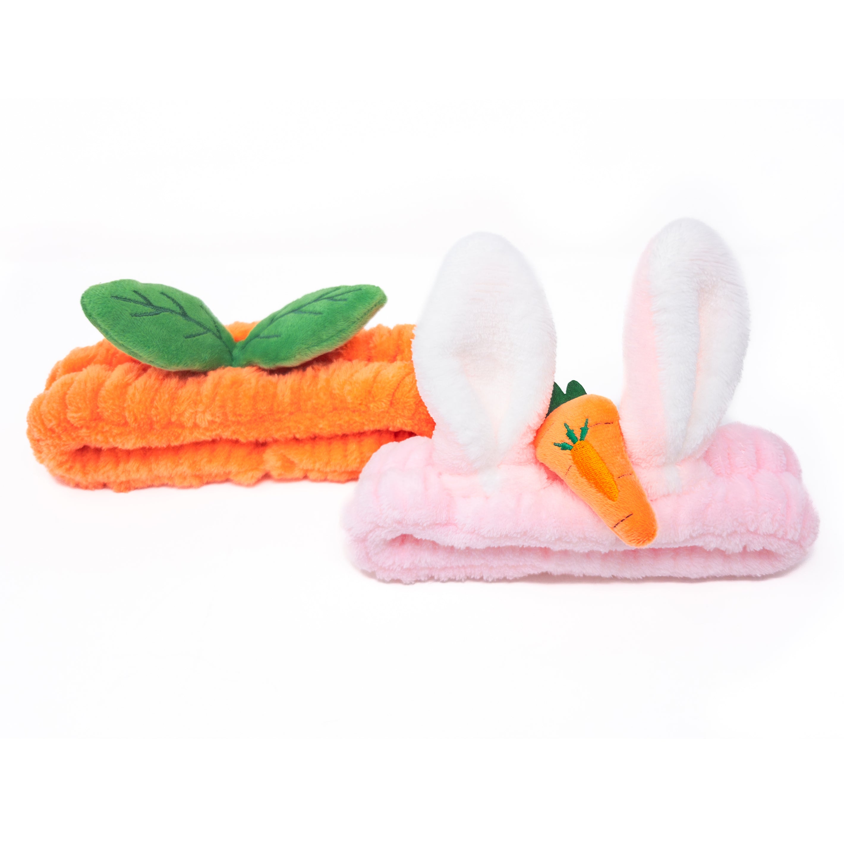 Two plush headbands, one carrot-shaped and one with bunny ears.