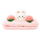 Pink plush headband with bunny and strawberries.