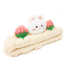 Fuzzy cream-colored headband with a white bunny face and pink strawberry decorations.