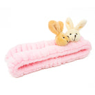 Pink plush headband with two rabbit heads.