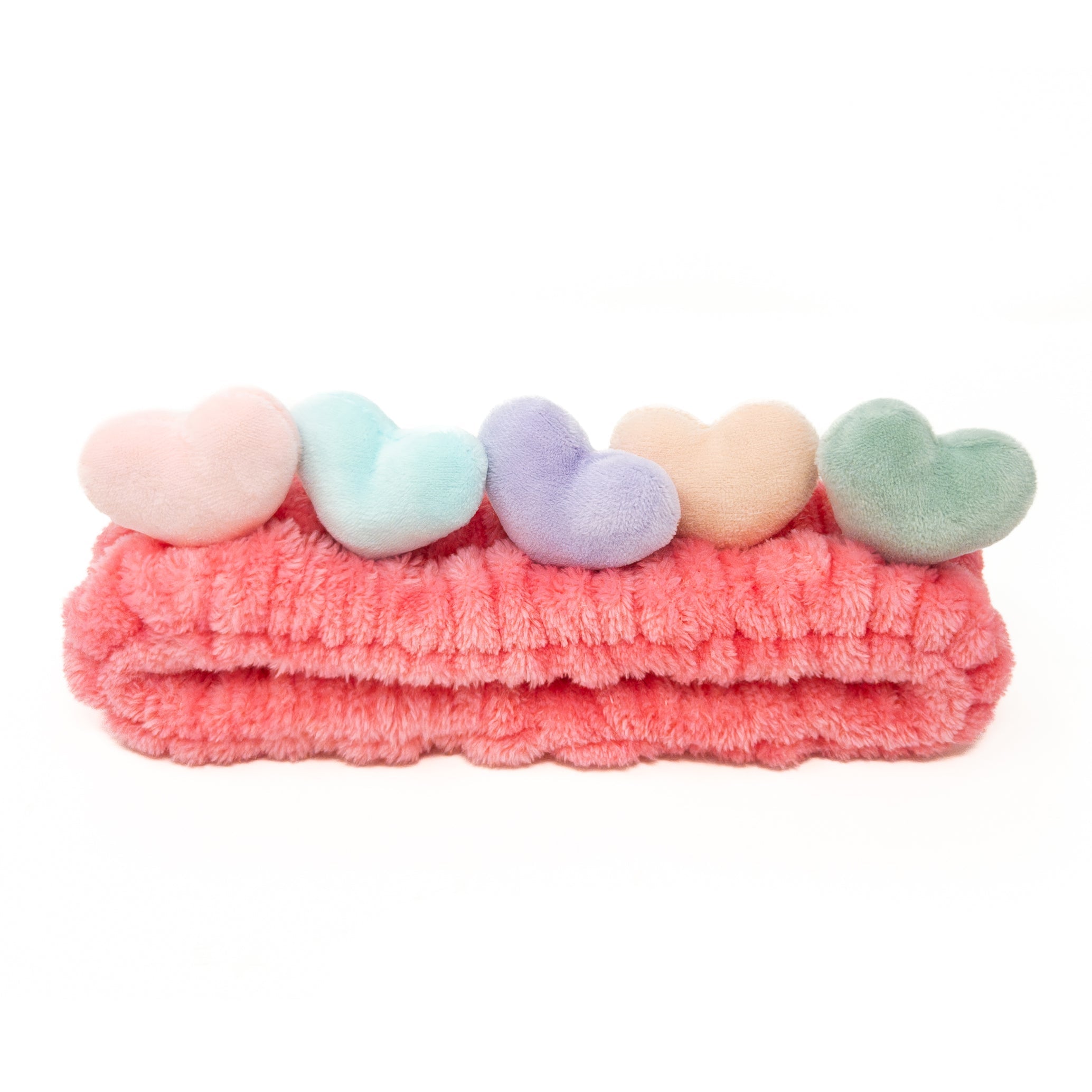 Pink headband with five pastel-colored heart accents.
