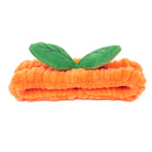 Orange plush headband with green leaves.