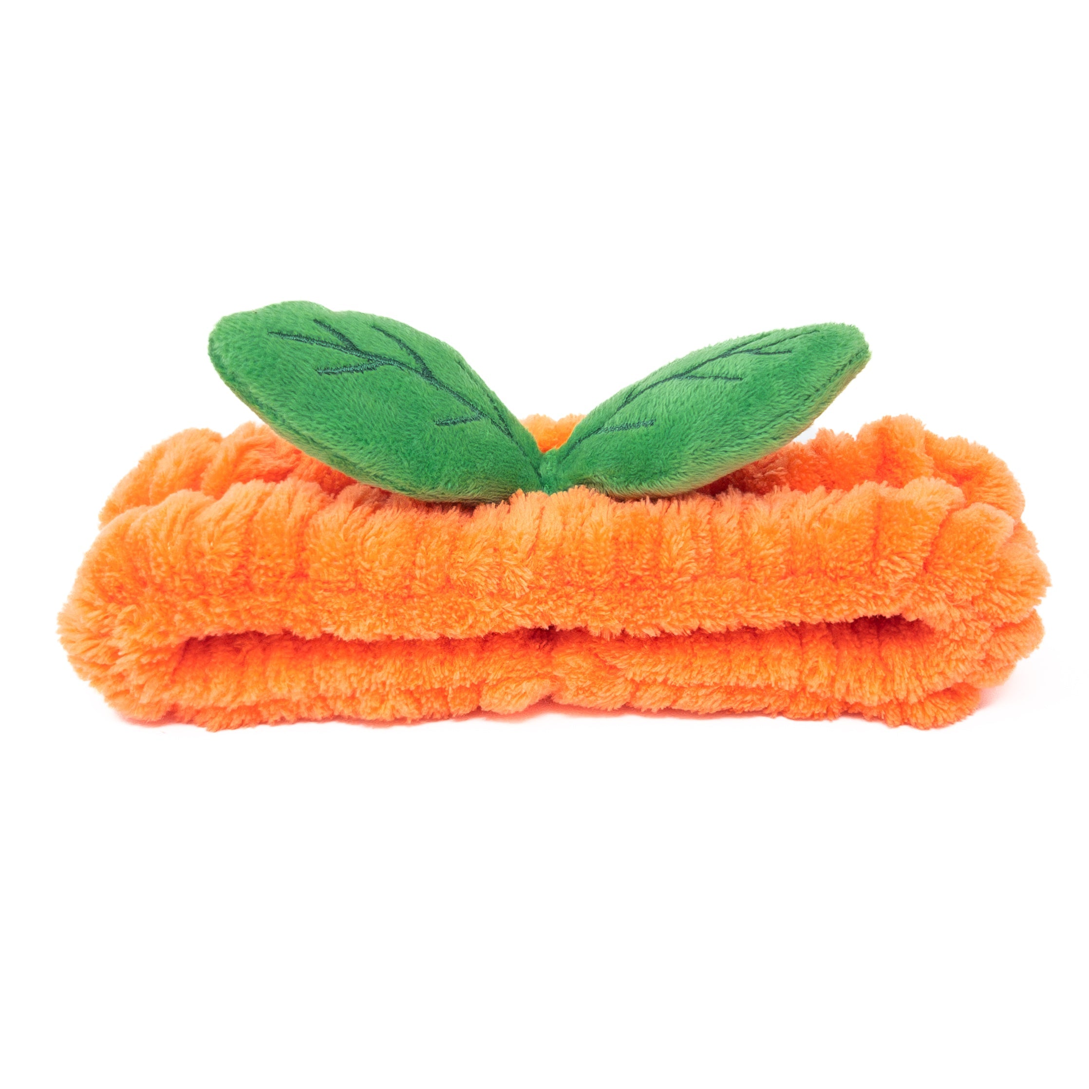 Orange plush headband with green leaves.