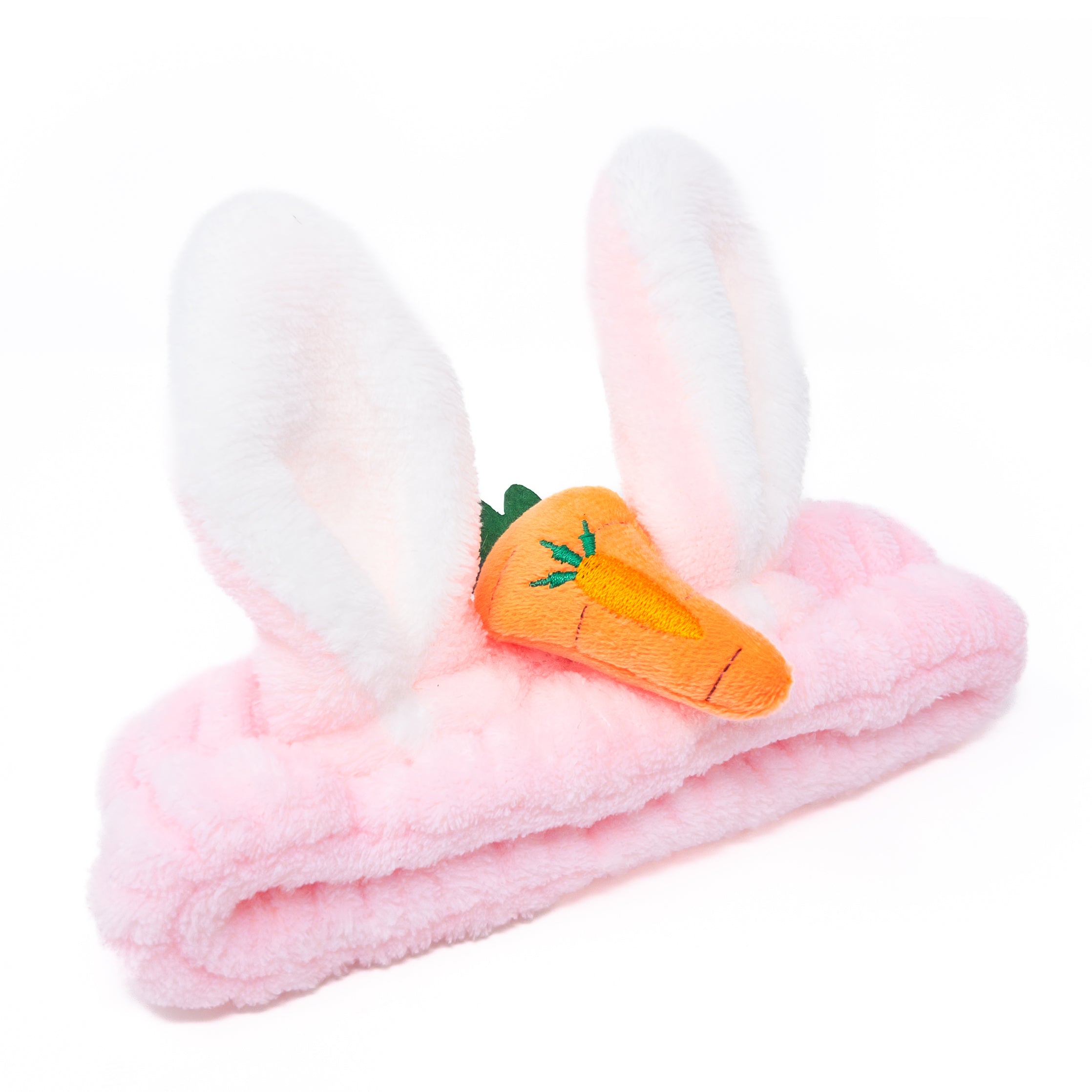 Pink fuzzy headband with white bunny ears and plush carrot accent.