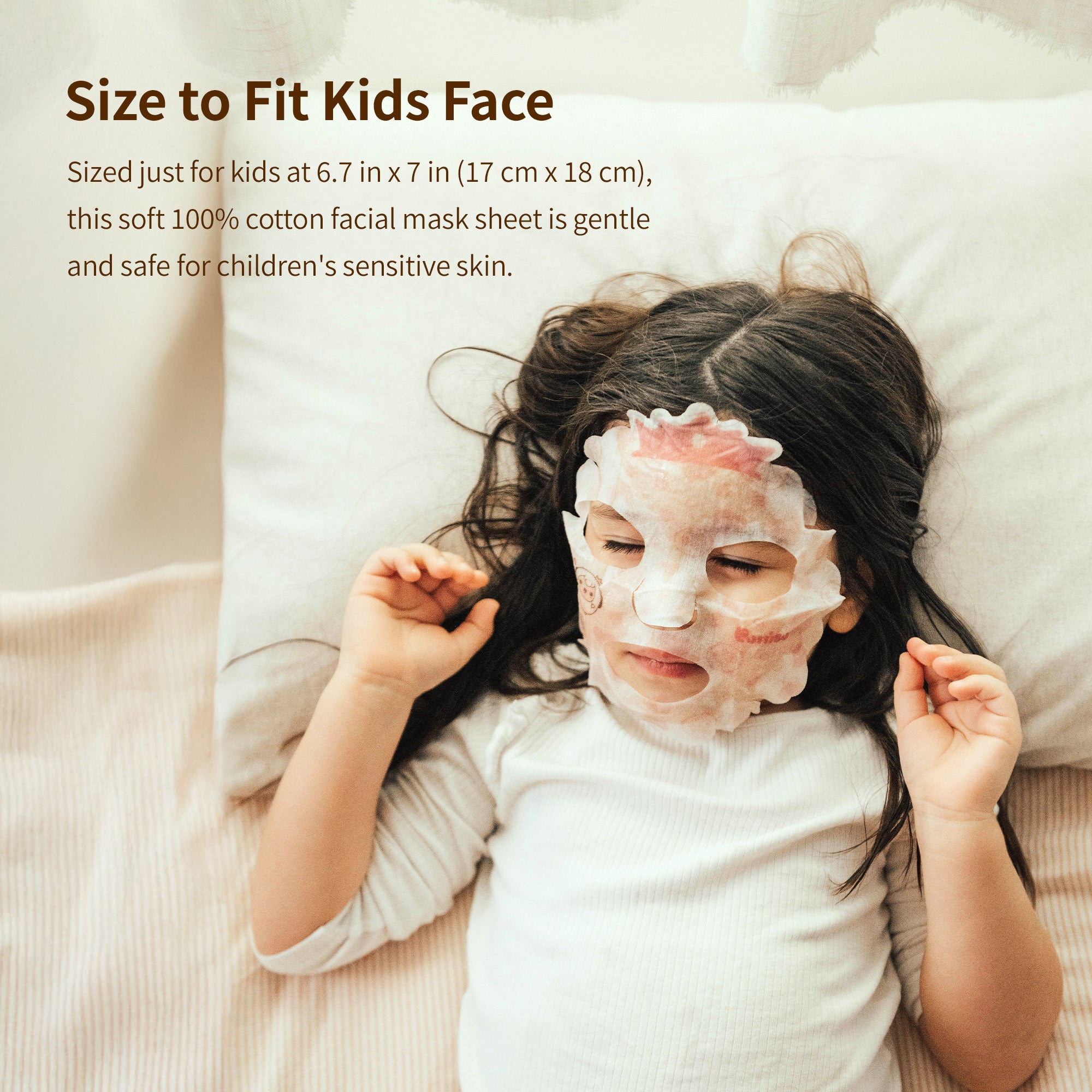 Child wearing a face mask while laying on a pillow.