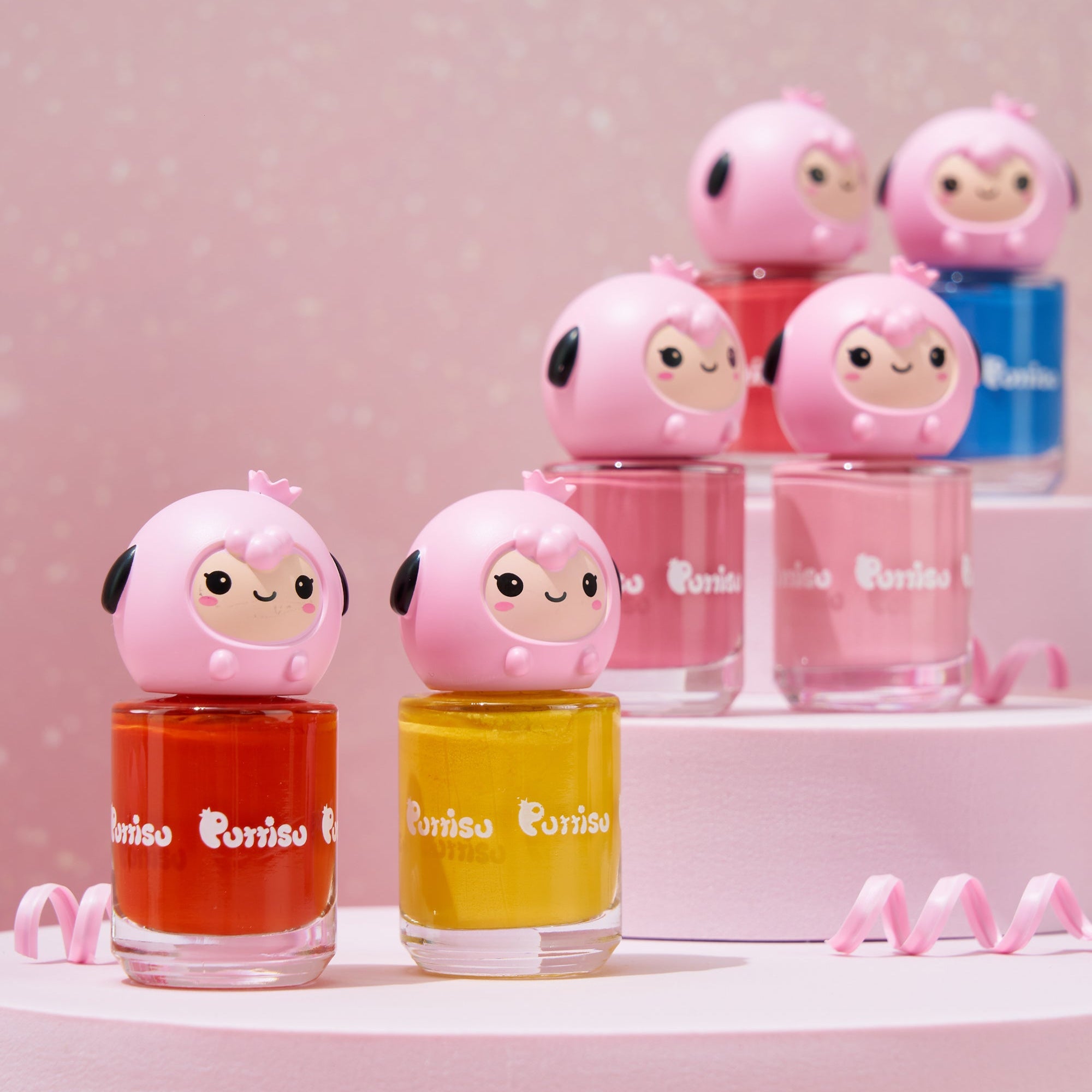 Six nail polish bottles with cute cartoon tops in an assortment of colors.