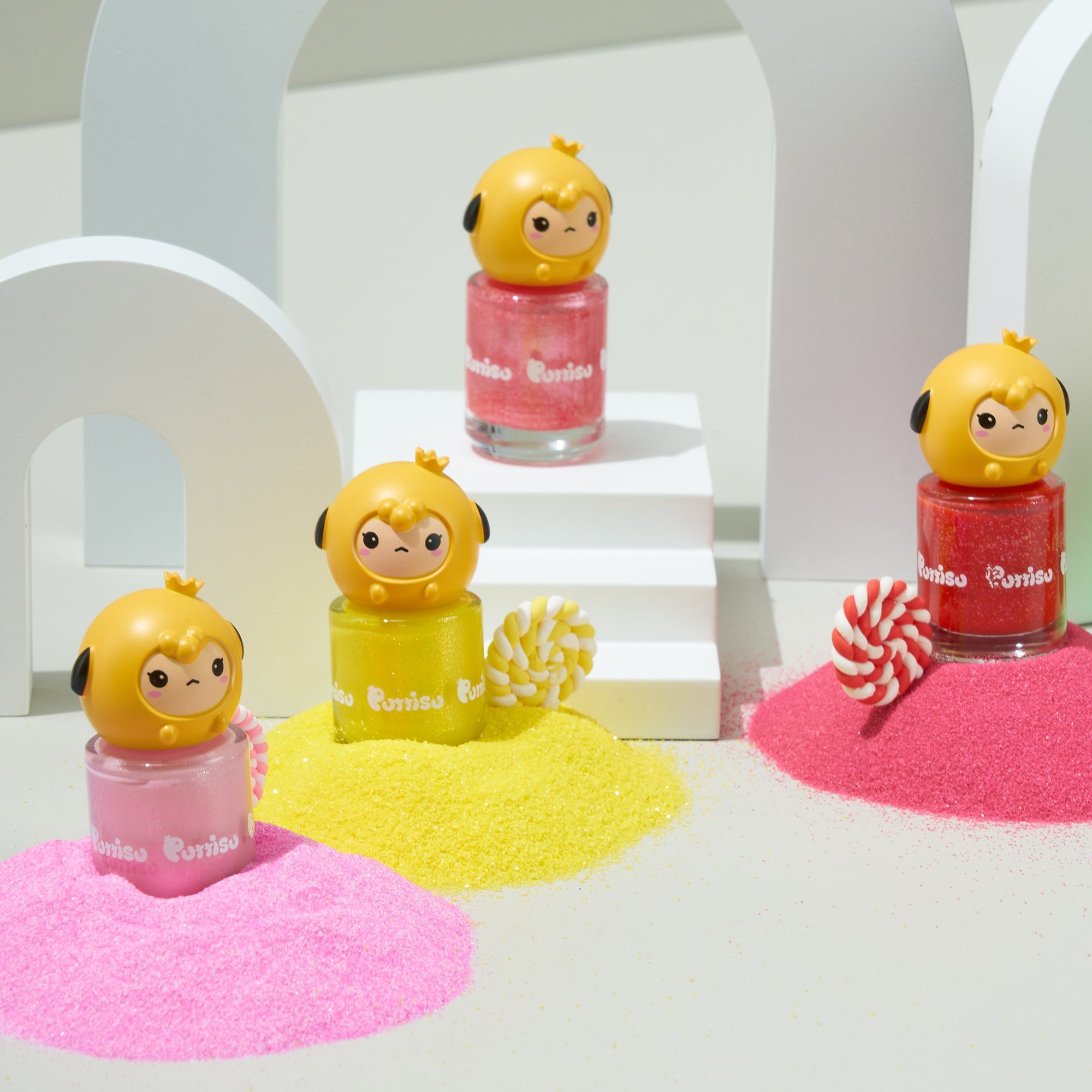 Nail polishes with cartoon character caps, colorful sand, and decorative arches.