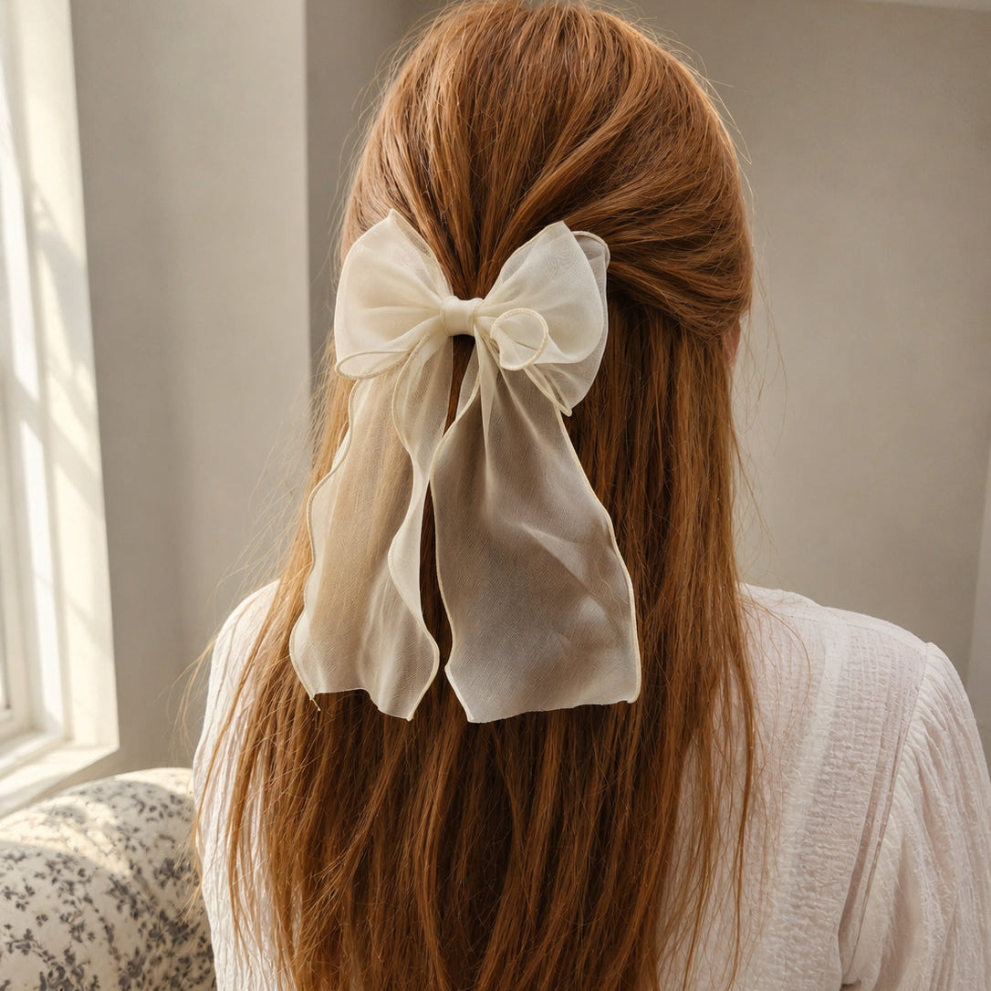 Sheer cream Organza Large Bow Clip on long reddish-brown hair, styled with a white textured shirt, seen from the back.