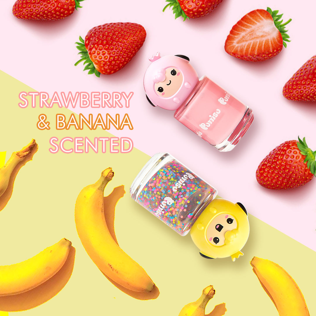 Product shot of two bottles of Purisu nail polish, one with a pink cartoon sheep head and pink polish and the other with a yellow cartoon bird head and polish filled with colorful candy-like pieces, surrounded by strawberries and bananas, with text "Strawberry & Banana Scented" layered on top.