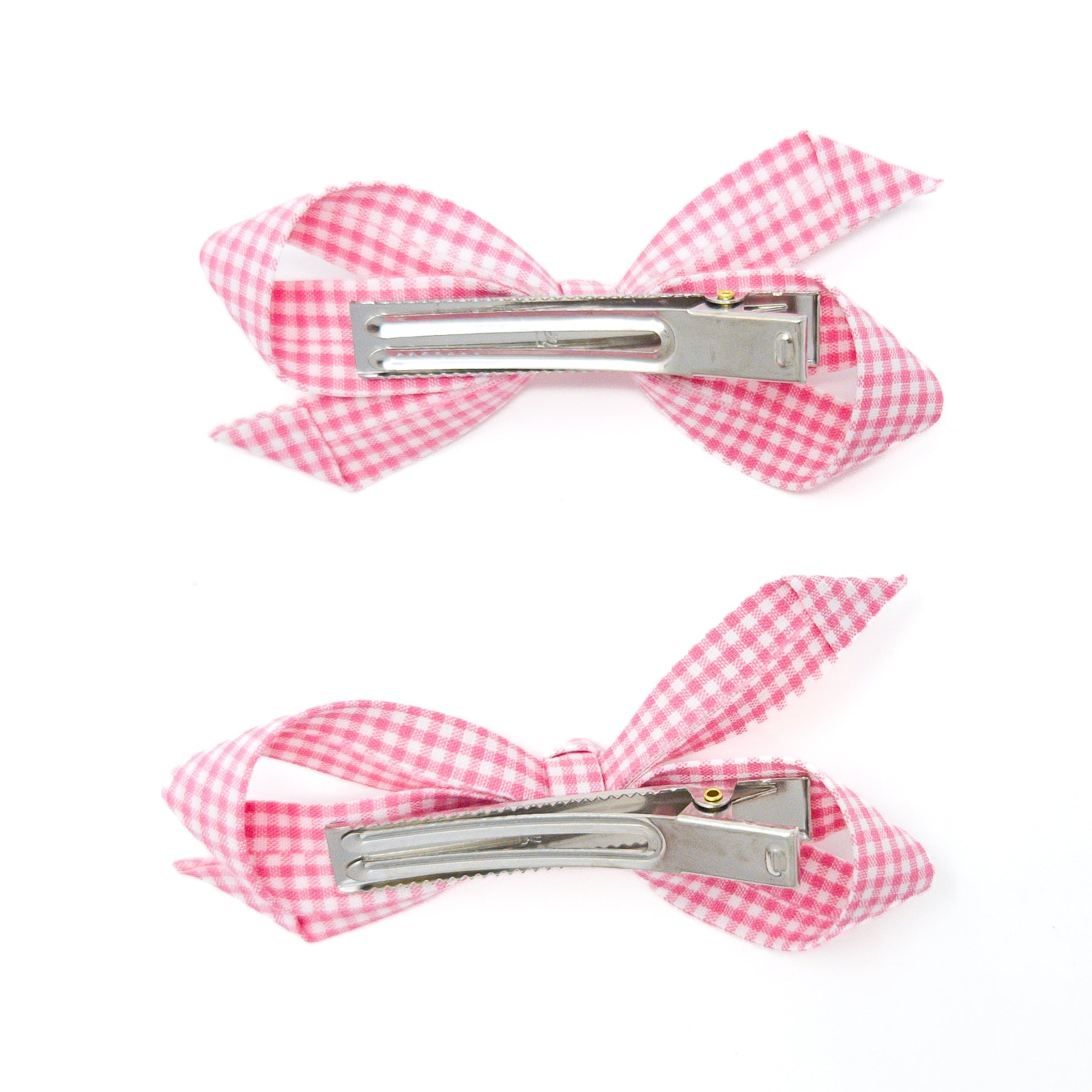 Two pink gingham ribbon hair clips with silver metal barrettes.