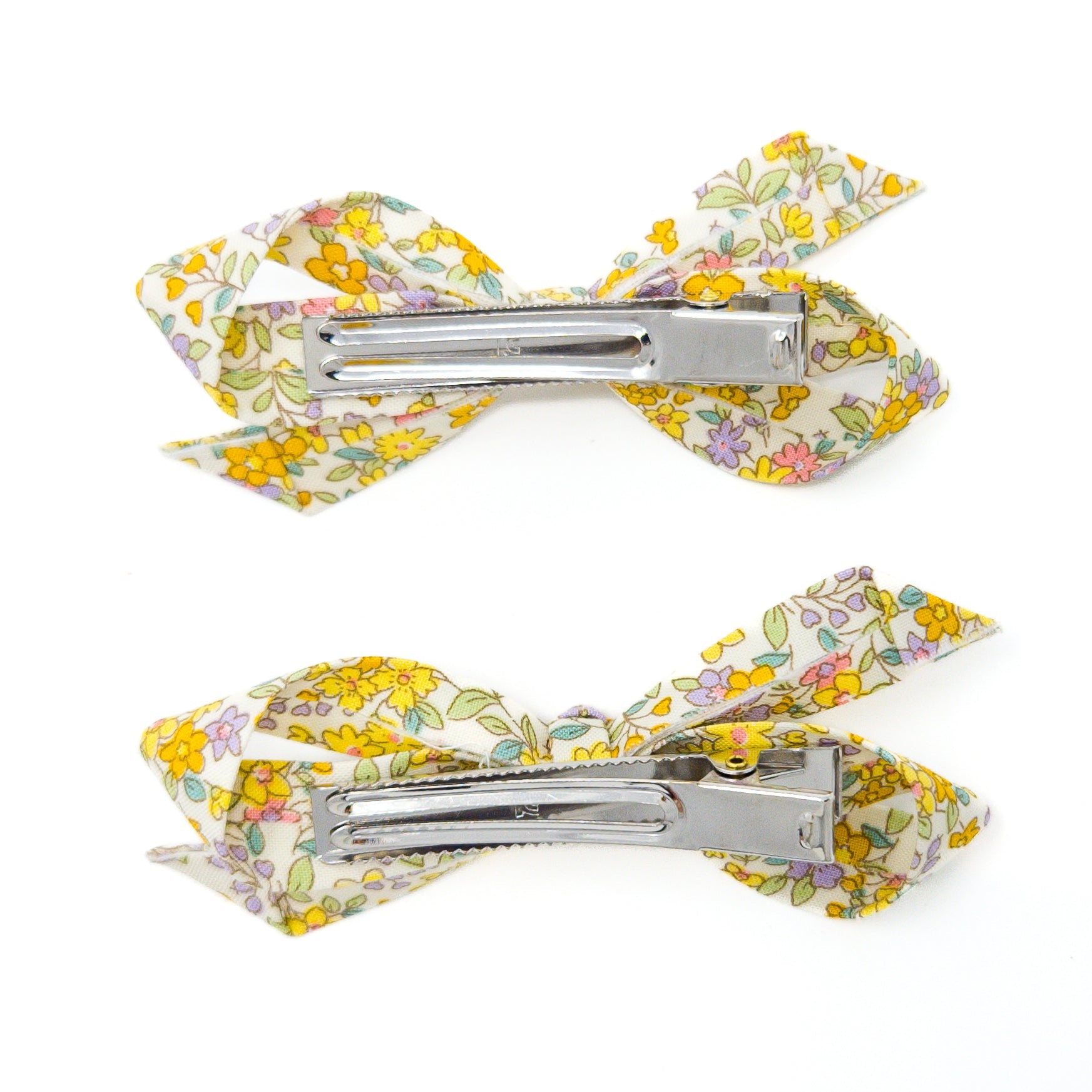 Two floral hair clips with metal fasteners.