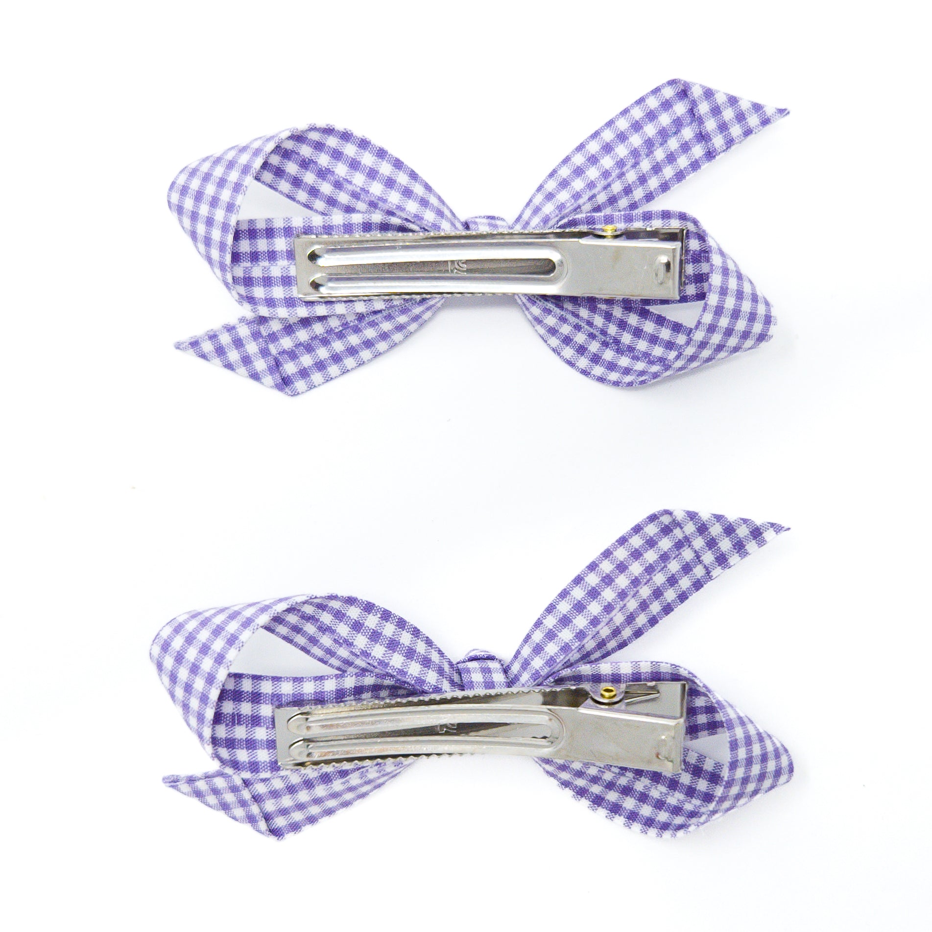 Two purple and white gingham hair clips.