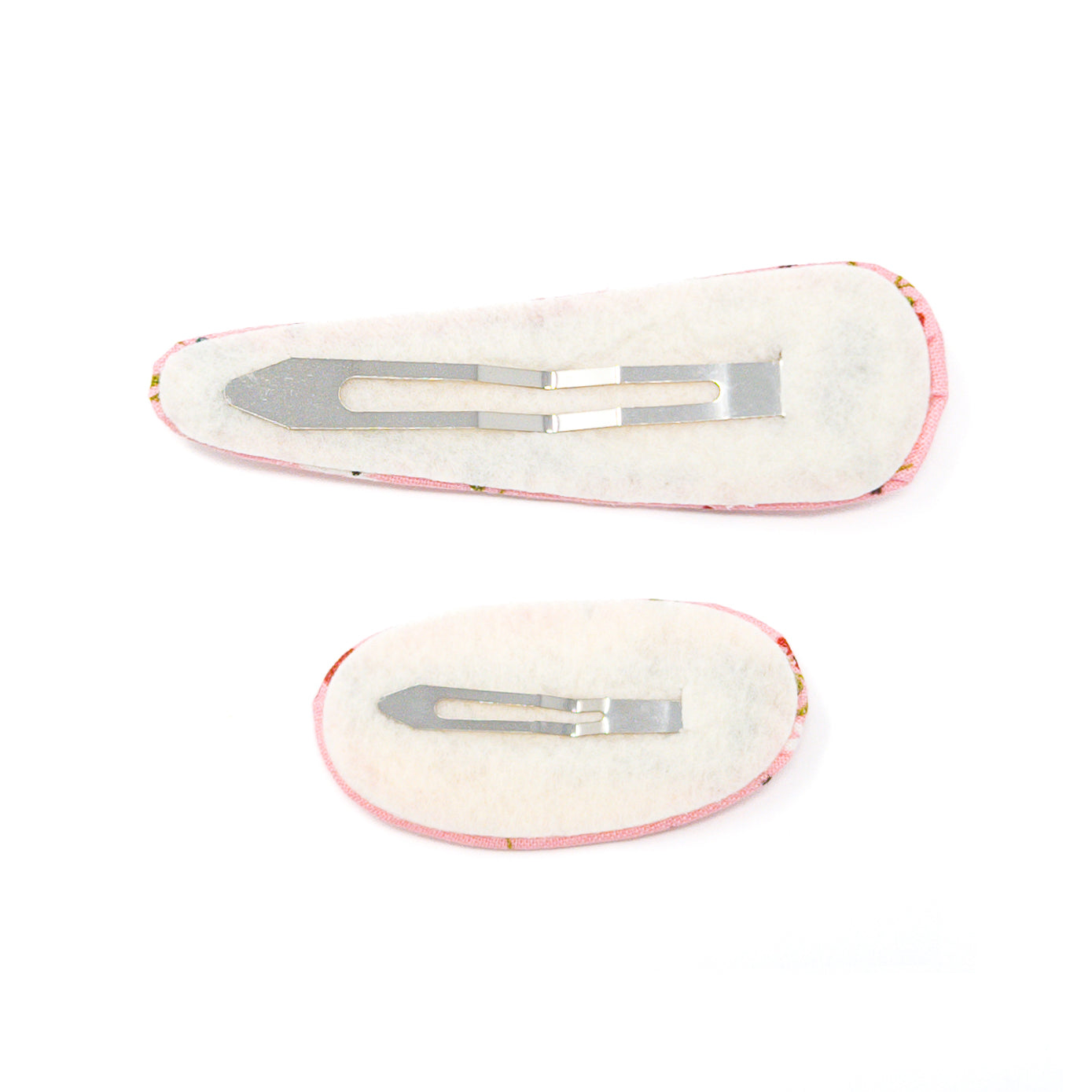 Two pink floral fabric-covered hair clips with metal clasps on a white background.
