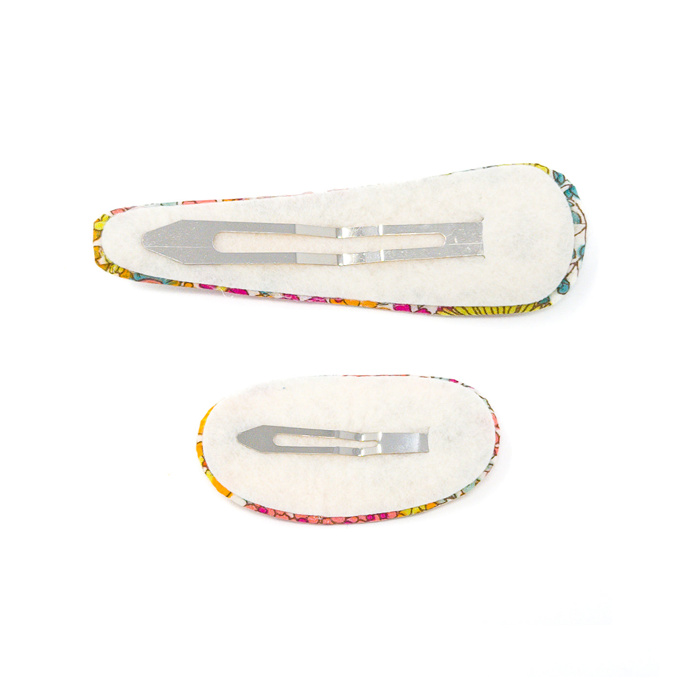 Two hair clips with colorful patterned fabric and felt backing.