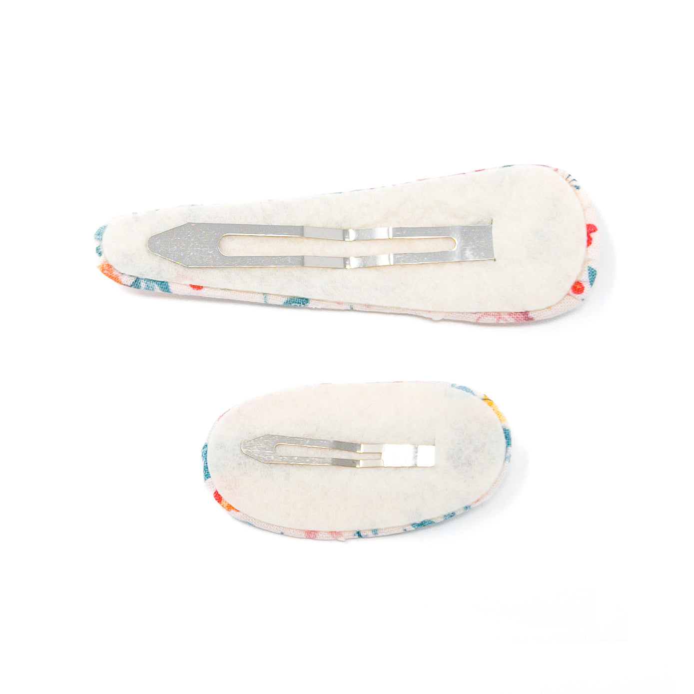 Two fabric-covered hair clips with metal fasteners, shown from the back.