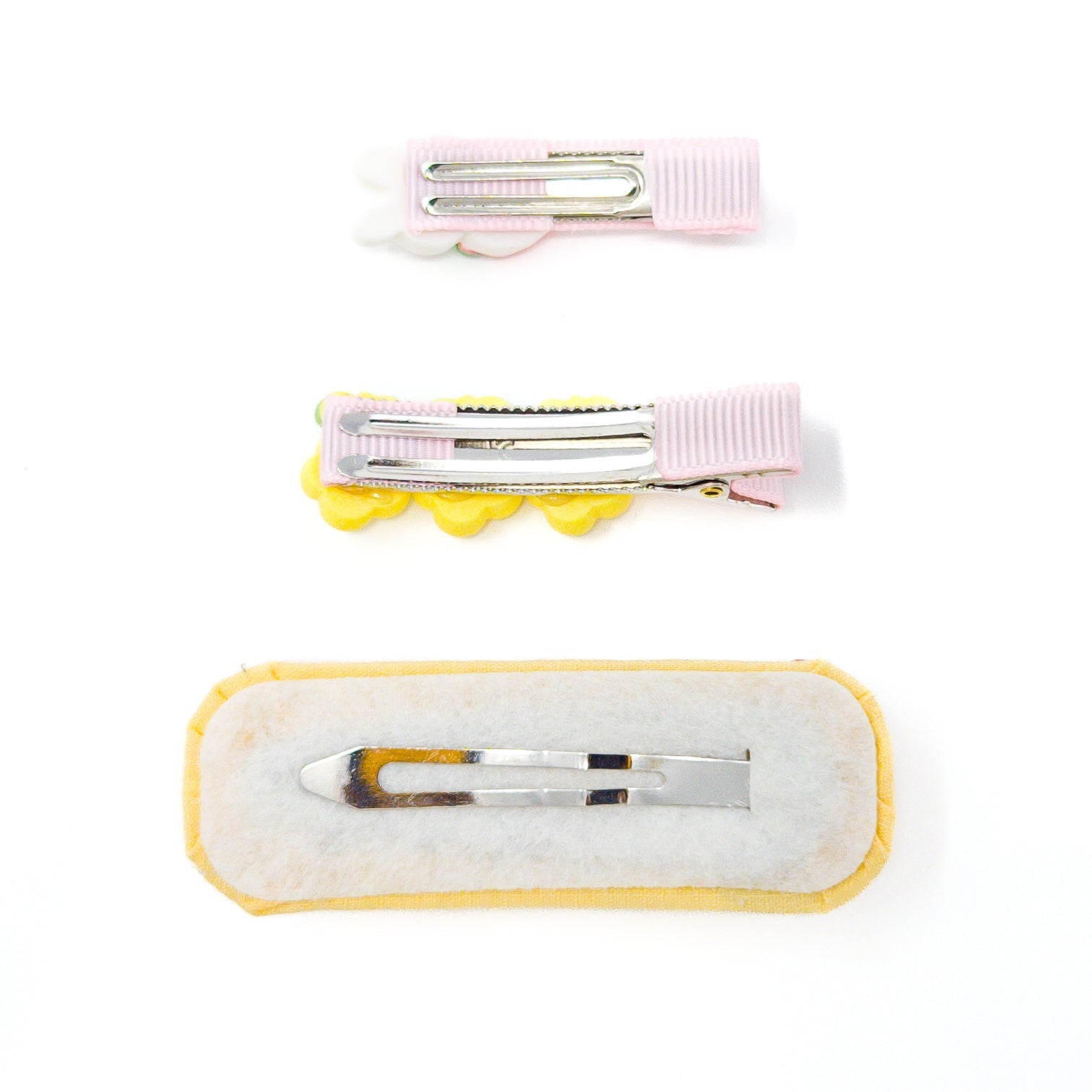 Three decorated hair clips.