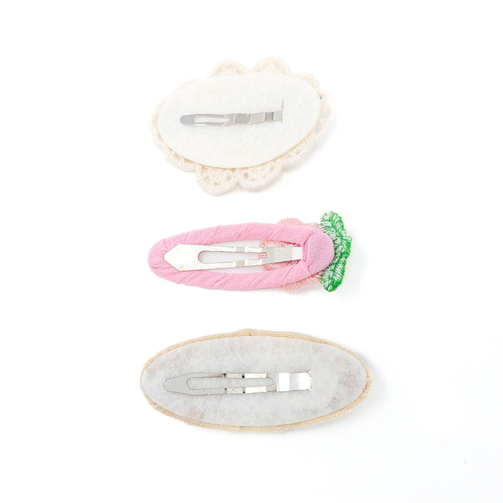 Three hair clips with metal clasps.
