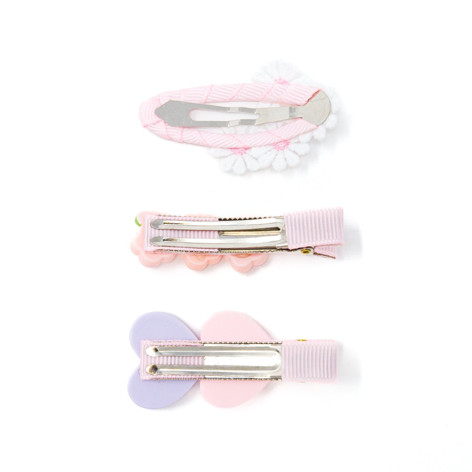 Three decorative hair clips with pastel colors on a white background.