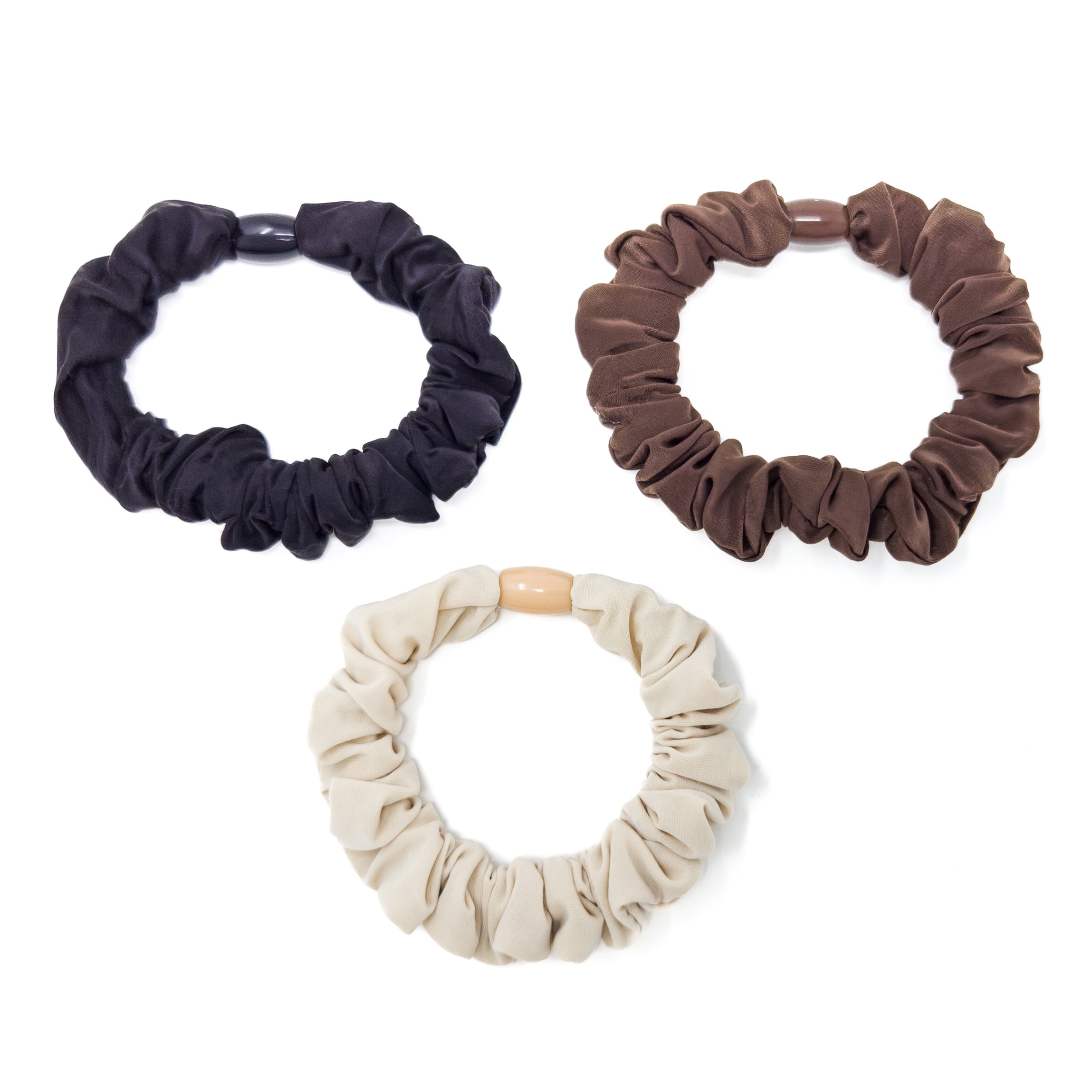 Three cloth-covered elastic hair ties in black, brown, and cream, each with a plastic or wooden bead.