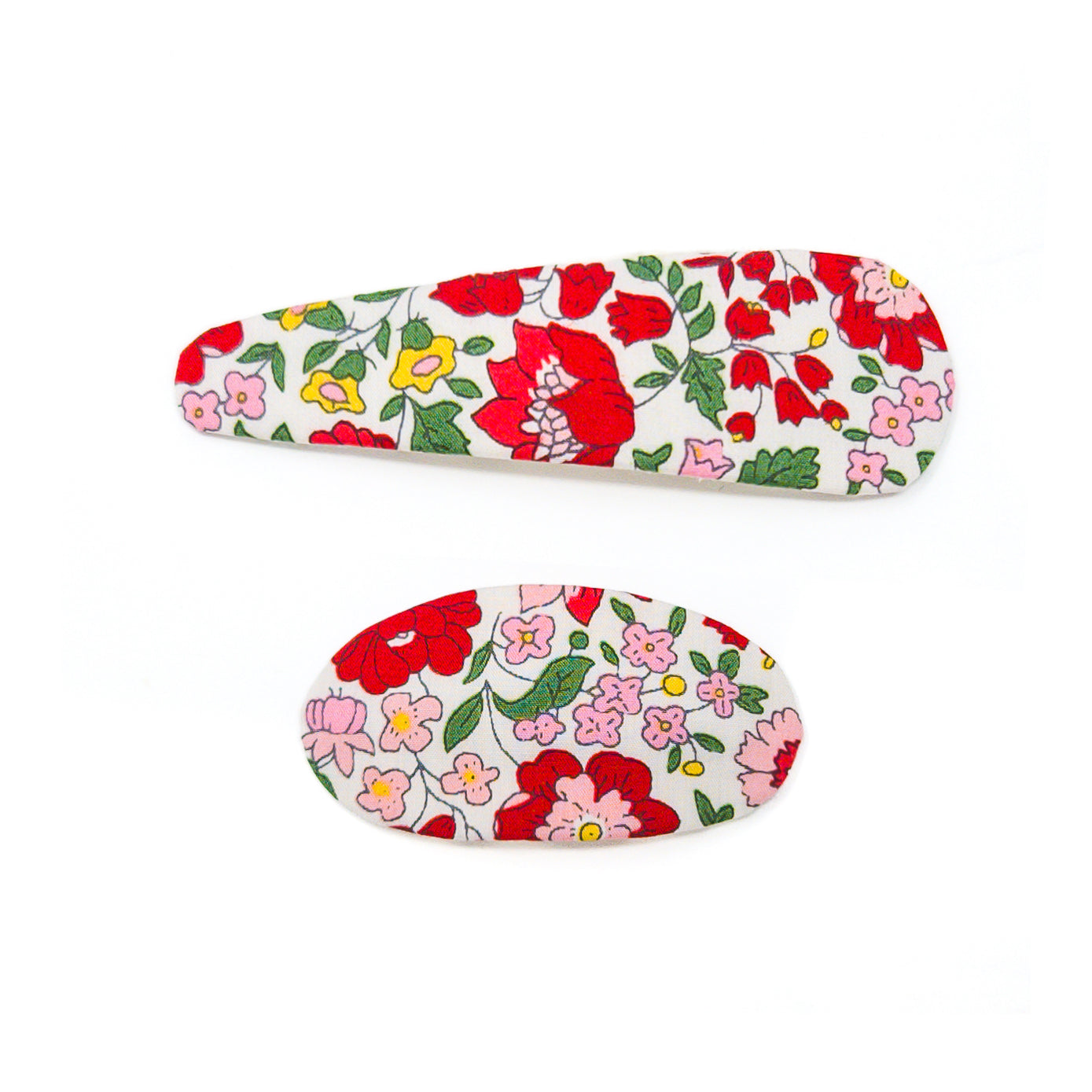 Two fabric-covered hair clips, one oval and one oblong, with a floral pattern in red, pink, yellow, and green on a white background.
