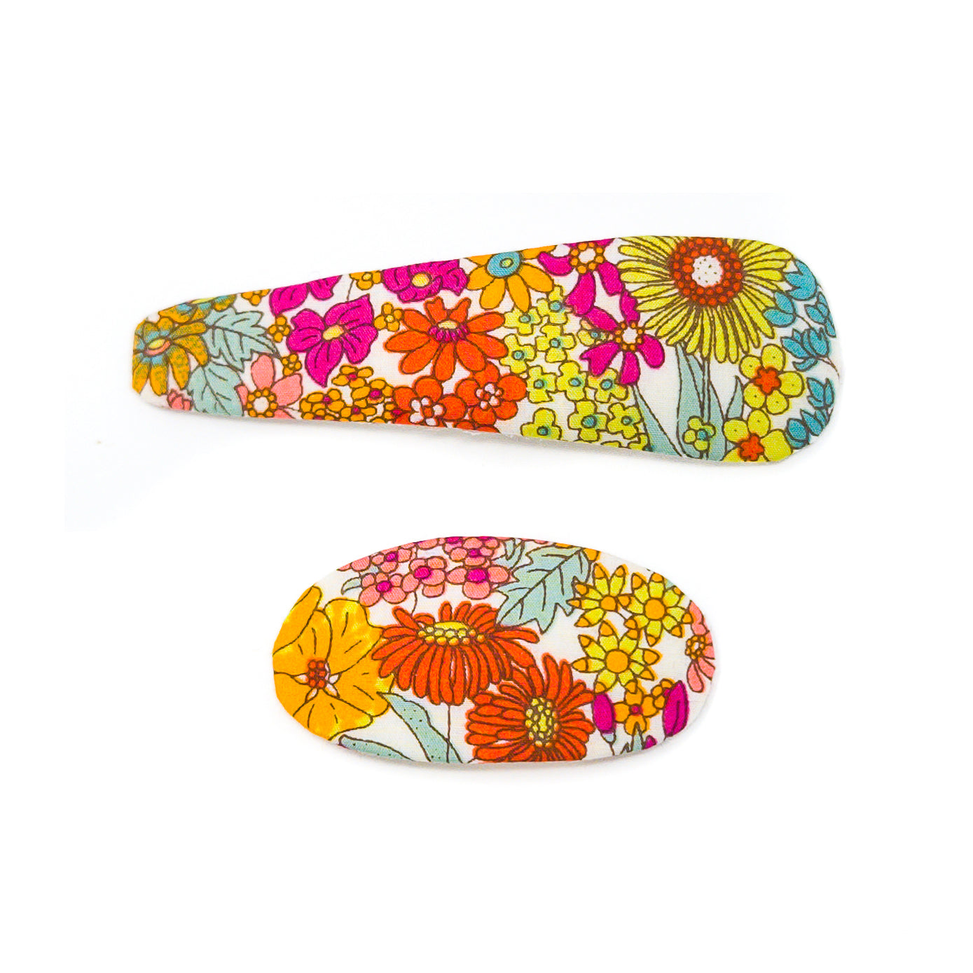 Two hair clips with a floral print, one oval and one petal-shaped, on a white background.