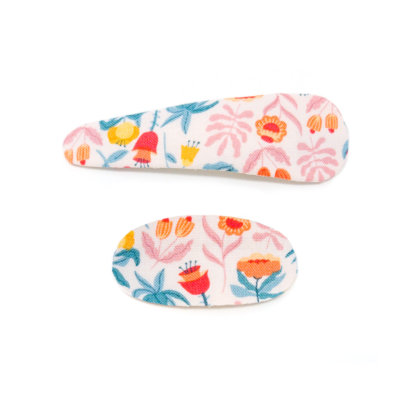 Two fabric-covered hair clips with floral prints.