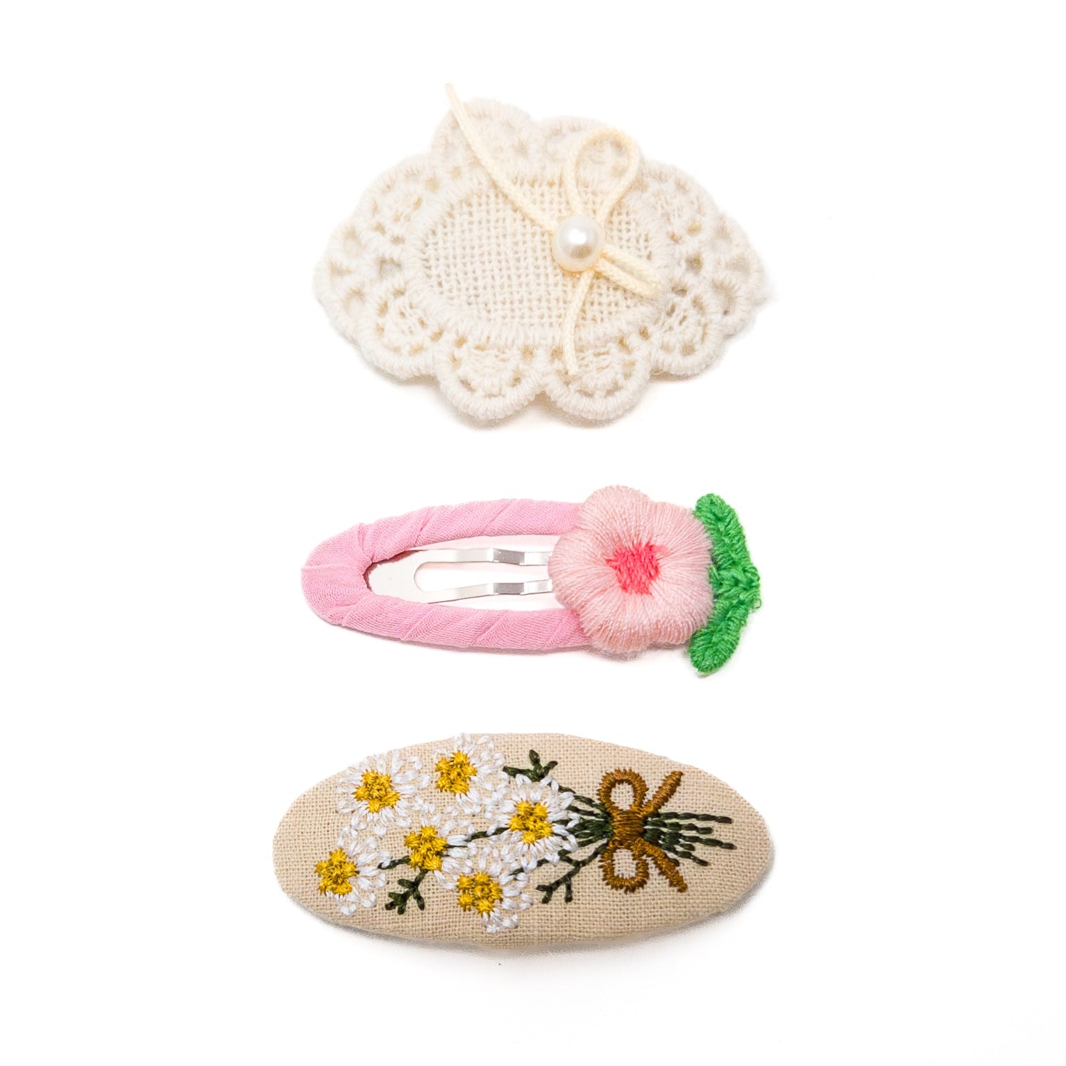 Three hair clips with embroidery.