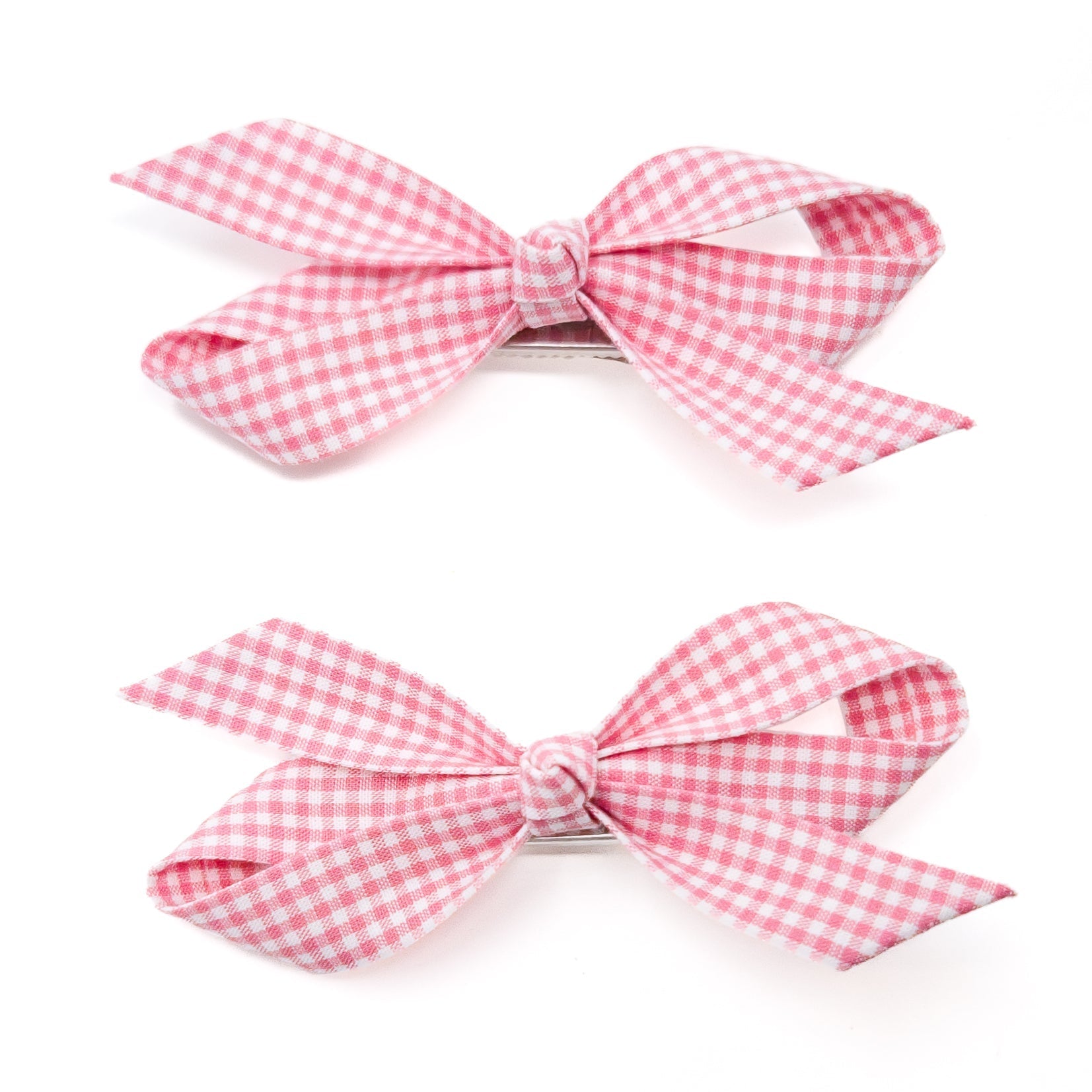 Two pink and white gingham ribbon hair bows.