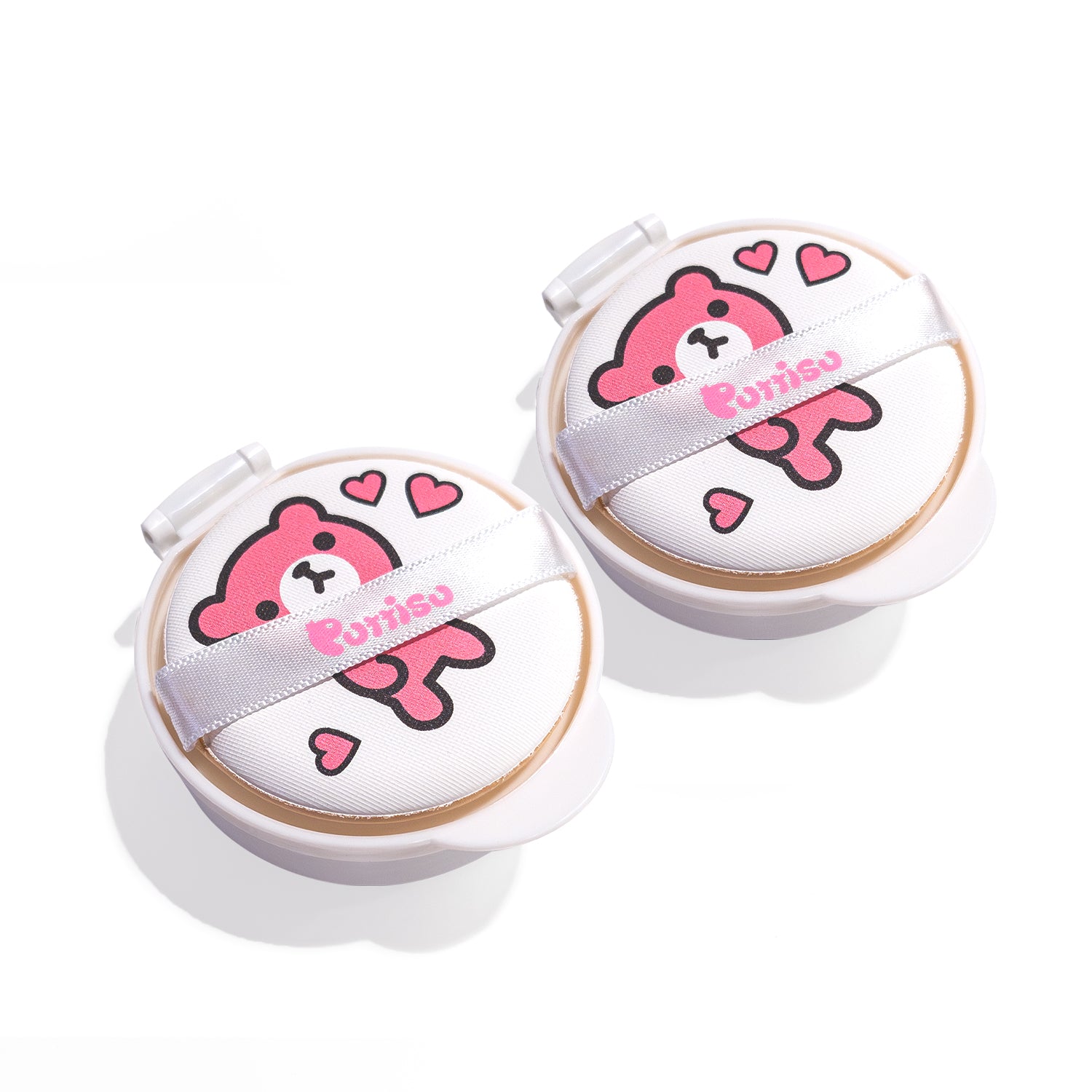Two white cushion compacts with pink bear designs and white ribbon straps.