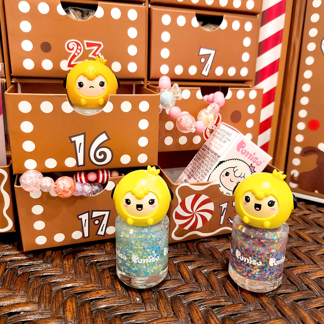 Here is an alt tag for the image:
Two bottles of glittery nail polish with yellow, cartoon-character caps sit in front of a brown advent calendar with white polka dots.