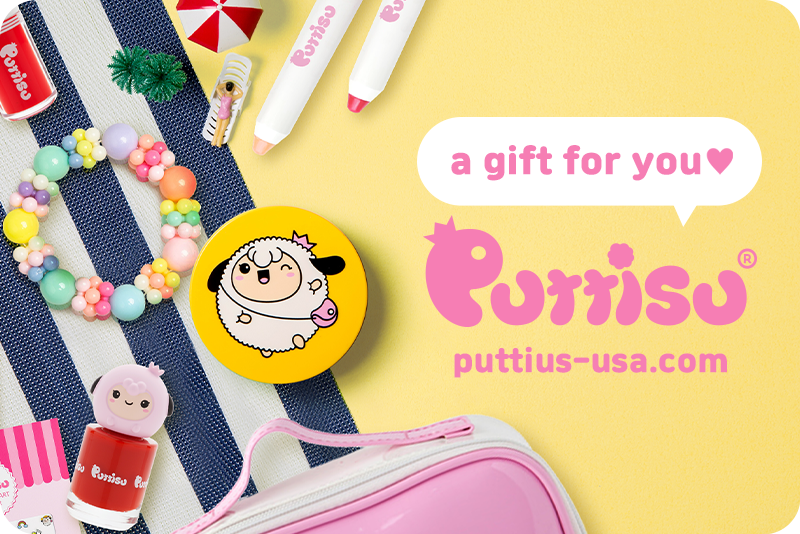 An overhead shot of a summer-themed display showcasing a colorful beaded bracelet, a yellow compact mirror with a cartoon sheep design, red nail polish with a sheep character cap, and a pink cosmetic bag, against a backdrop of blue and white stripes and bright yellow. The image also features a speech bubble saying "a gift for you" and the brand logo.