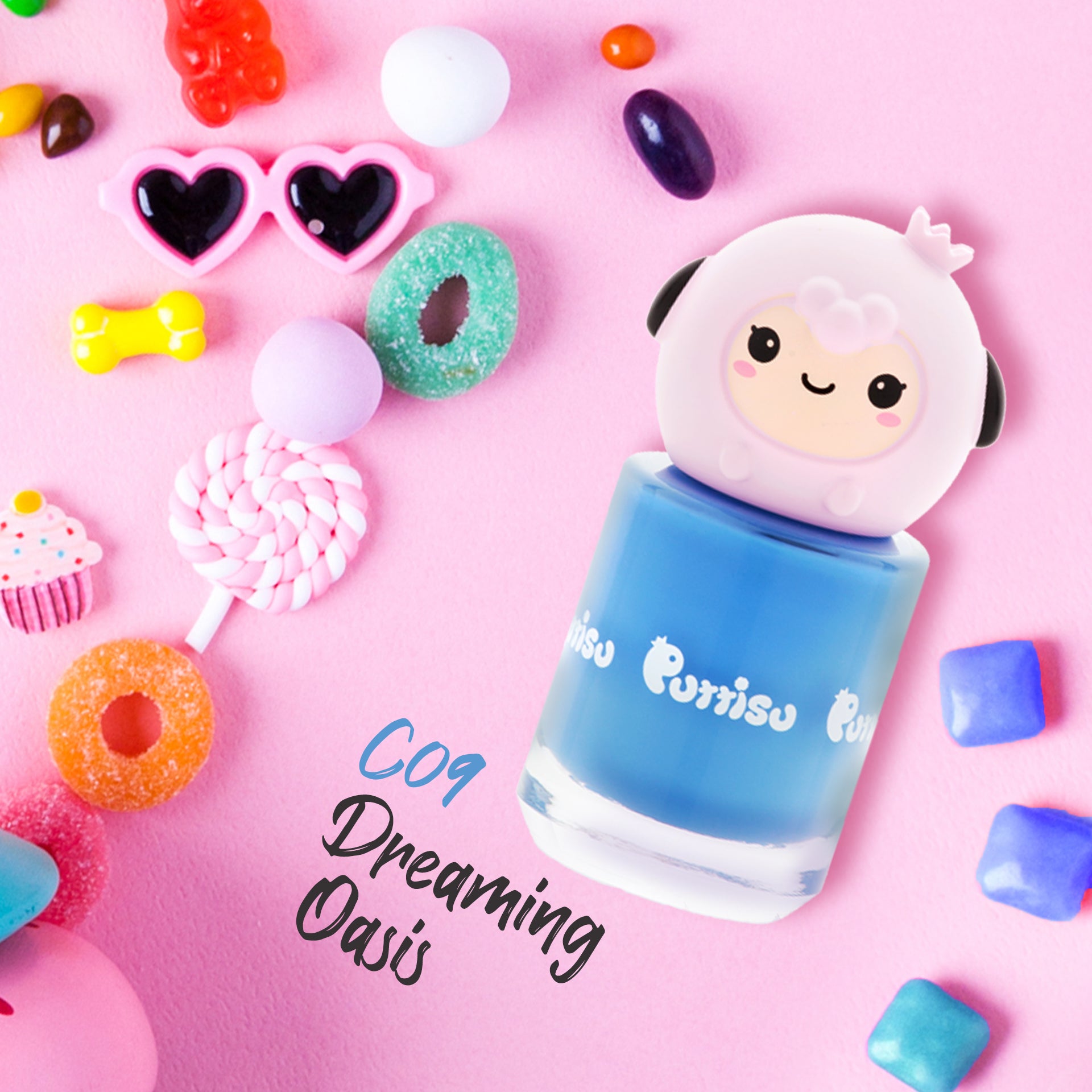 Blue nail polish bottle with a sheep-shaped cap, surrounded by candy on a pink background.