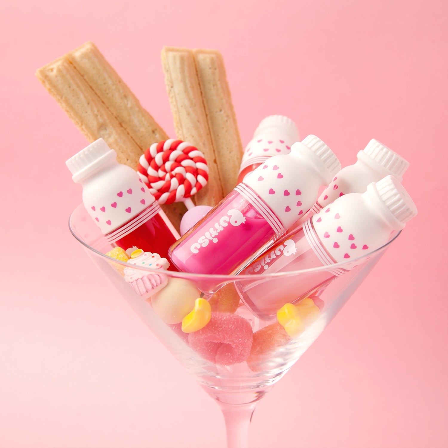Martini glass with lip glosses and candies.