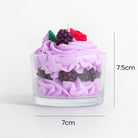 Dessert cup soy wax candle with lavender frosting, by unbranded, with artificial berries in a clear glass holder.
