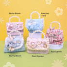 Five decorative bags labeled 'Petite Bloom', 'Princess Tiara', 'Bunny Bloom',  'Pearl Garden', and 'Bunny Belle' on a yellow and green background.