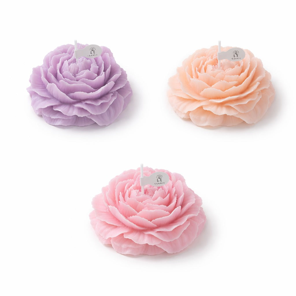 Pastel flower shaped Jellycup Peonie soy wax candles from Japan, with small white paper flags.