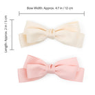 Two large satin double bow clips in blush pink and ivory, with dimension measurements.