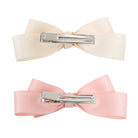 Large satin double bow clip set in blush and ivory, showing the back with metal alligator clips.