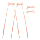 Light pink ribbon bow clip set featuring two bows with long trailing ribbons and two smaller bows.