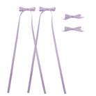Four-piece lavender ribbon bow clip set with two long trailing ribbons and two smaller bows.